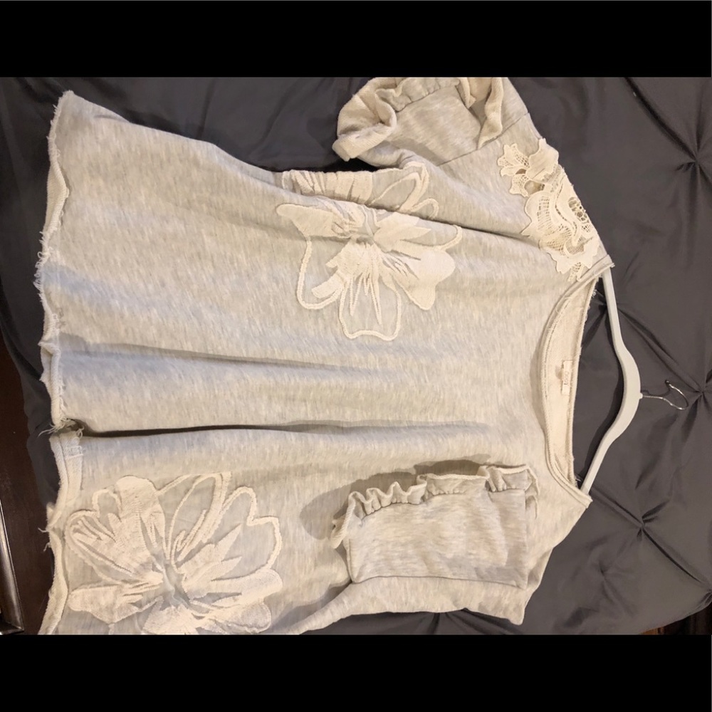 Cream top with floral appliqué